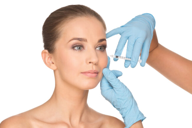 Attractive,Young,Woman,Gets,Cosmetic,Injection,,Isolated,Over,White,Background.
